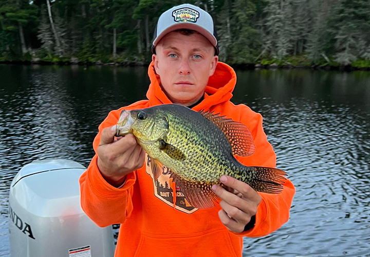 image of young man holding big crappie caught near ely mn
